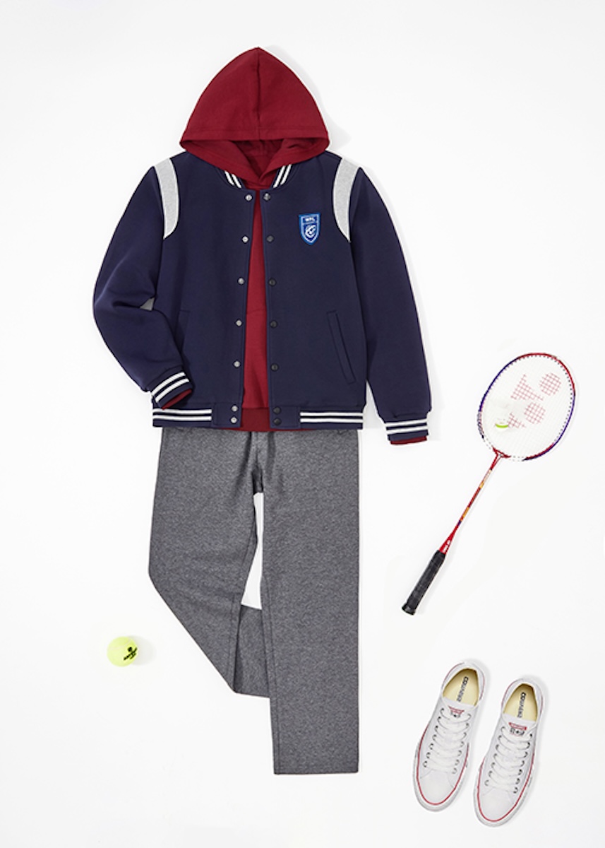 Flat lay of a varsity jacket, hoodie, joggers, trainers and a badminton racket
