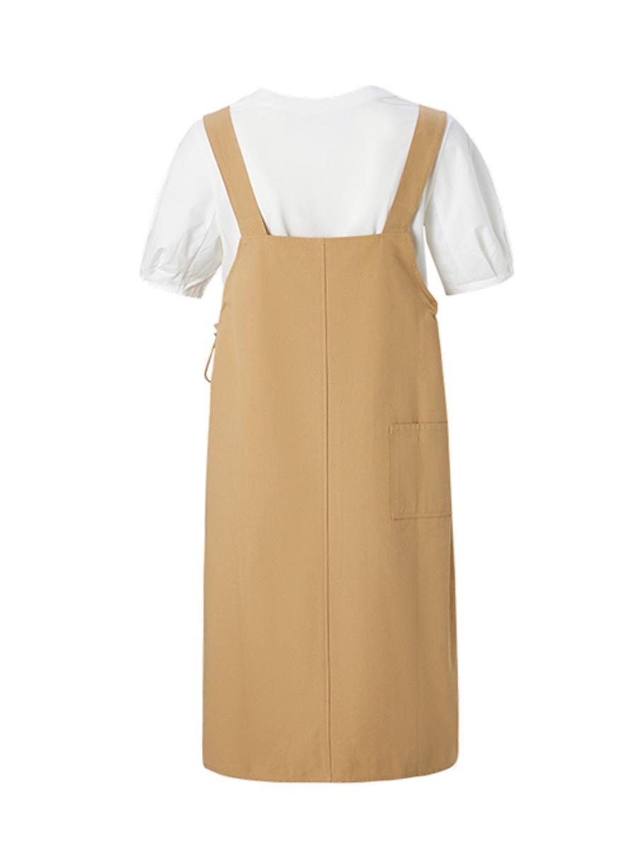 Back view of a khaki pinafore dress over a white tee with a patch pocket