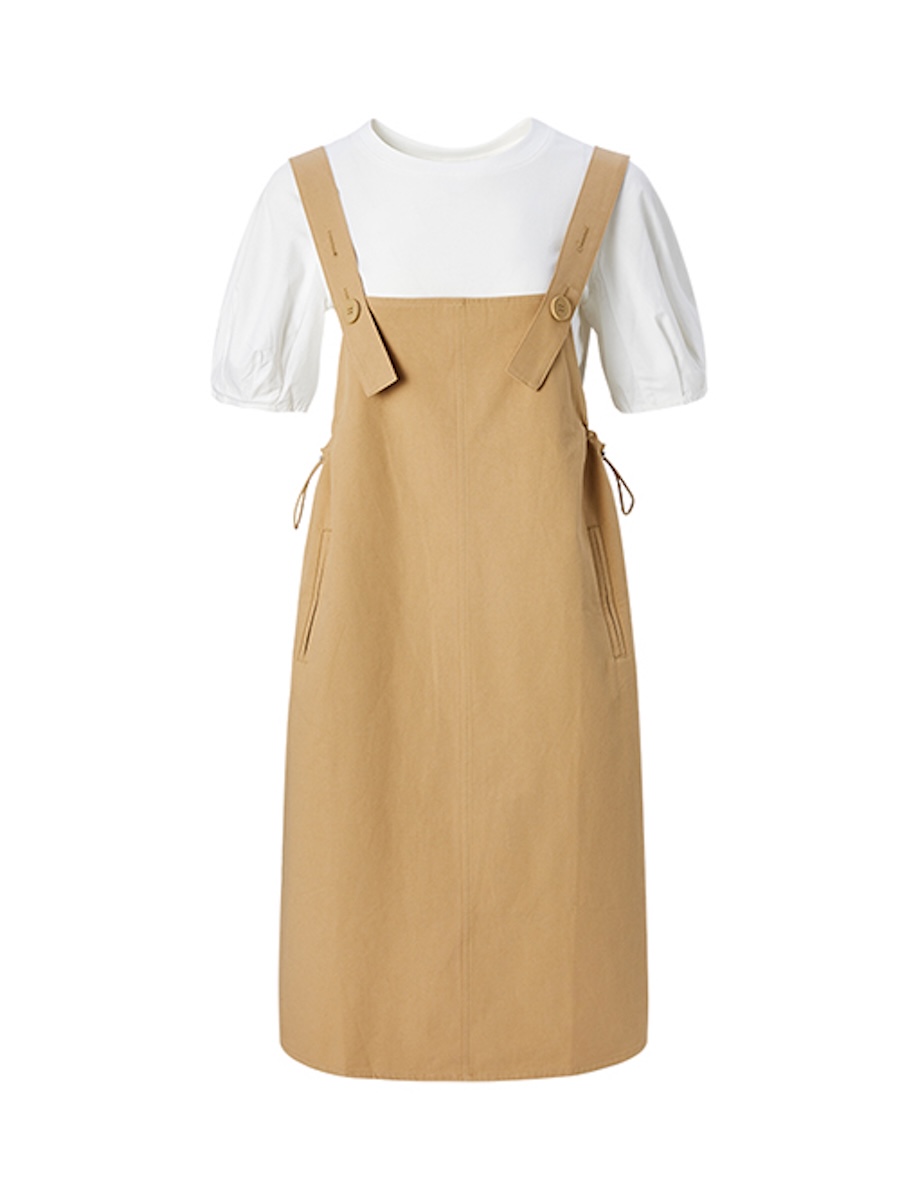Khaki pinafore dress layered over a white puff-sleeve tee, ghost mannequin front view